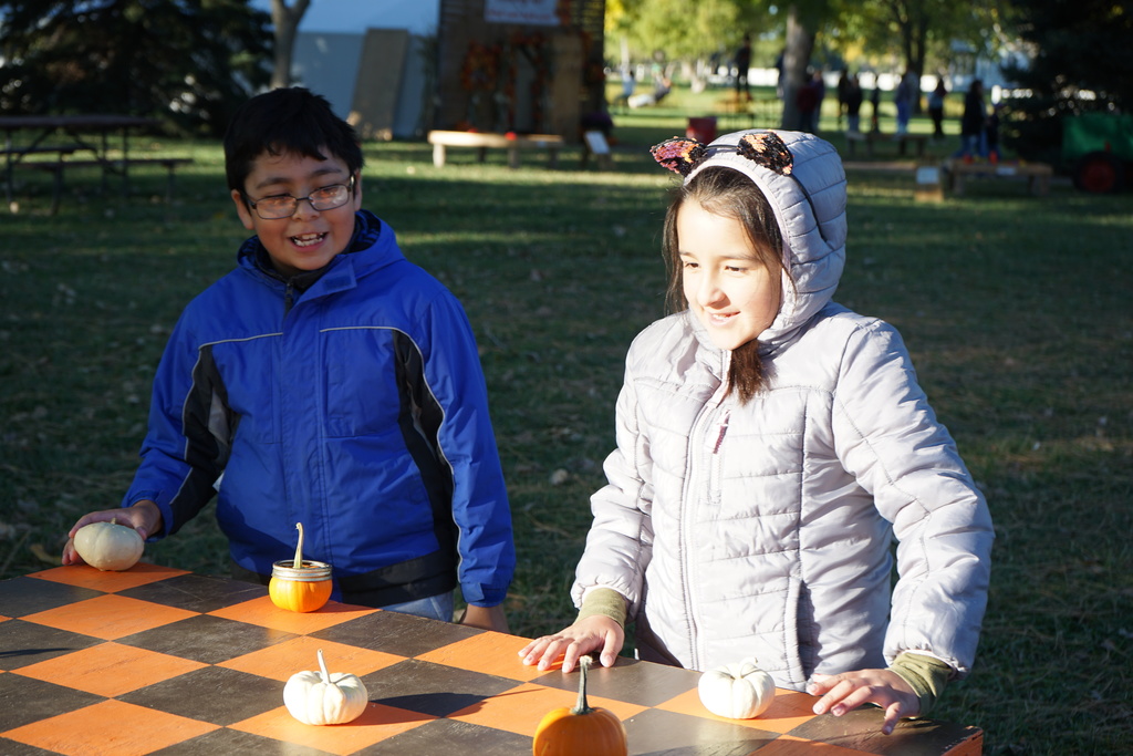 Kids Klub students playing pumpkin checkers at the pumpkin patch.